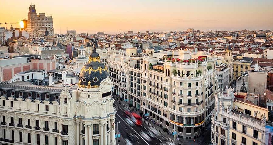 Madrid,,Spain,,Sunset,Over,Landmark,Buildings,On,Gran,Via,Street.